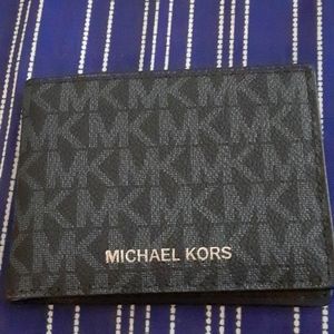Michael Kors small men's wallet. Black with blue MK lettering.